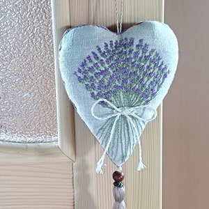 Handmade hand embroidered heart shaped linen sachet with hanging loop and tassel filled with lavender. Hung on door hanger. Embroidered lavenders.