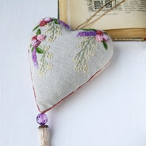 Handmade embroidered linen heart shaped home decor sachet, with hanging loop and tassel.