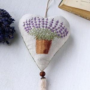 Linen handmade hand embroidered heart shaped sachet with tassel and hanging loop, filled with lavender. Finished embroidery. Embroidered pot with lavenders.