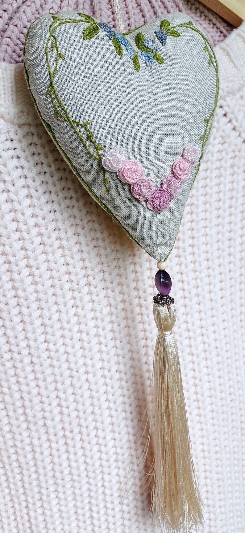 Hand embroidered linen sachet with tassel and hanging loop filled with lavender hanged on clothes hanger