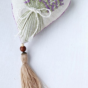 Handmade hand embroidered heart shaped linen sachet with hanging loop and tassel filled with lavender. Embroidered lavenders.