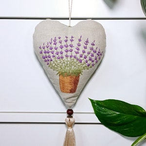 Linen handmade hand embroidered heart shaped sachet with tassel and hanging loop, filled with lavender. Finished embroidery. Embroidered pot with lavenders.