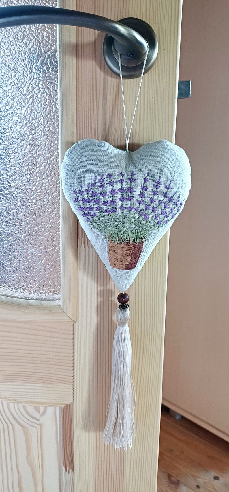 Linen handmade hand embroidered heart shaped sachet with tassel and hanging loop, filled with lavender. Finished embroidery. Embroidered pot with lavenders.