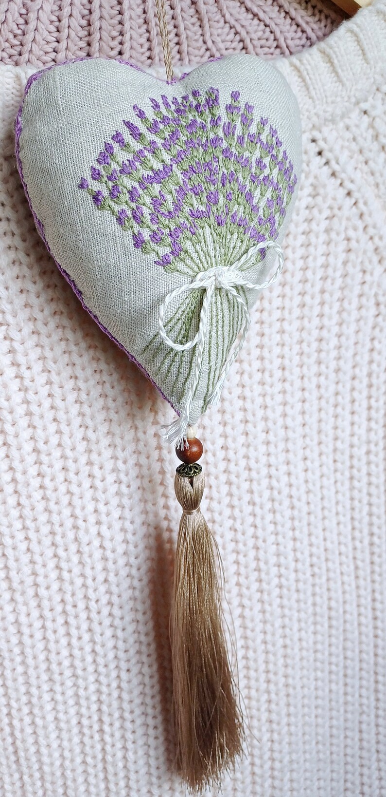 Handmade hand embroidered heart shaped linen sachet with hanging loop and tassel filled with lavender. Hung on cloth hanger. Embroidered lavenders.