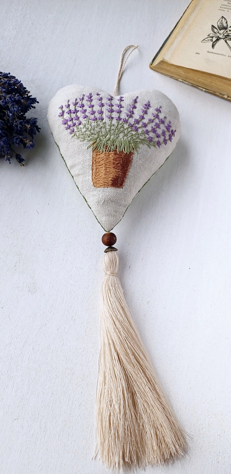 Linen handmade hand embroidered heart shaped sachet with tassel and hanging loop, filled with lavender. Finished embroidery. Embroidered pot with lavenders.