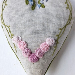 Hand embroidered linen sachet with tassel and hanging loop filled with lavender. Embroidered roses