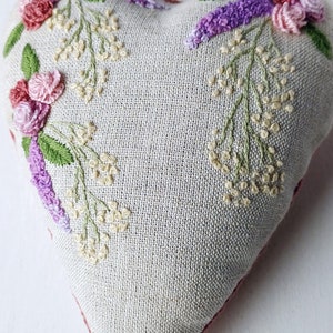 Handmade embroidered linen heart shaped home decor sachet, with hanging loop and tassel.