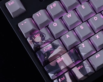 May include: Close-up of a black mechanical keyboard with gray keycaps and purple backlighting. The keycaps feature white lettering and a custom design on the Tab, Caps, Shift, Ctrl, and Win keys. The custom design features an anime-style illustration.