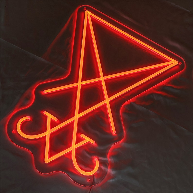 May include: A red neon sign in the shape of a five-pointed star with an inverted triangle inside. The sign is on a white background.