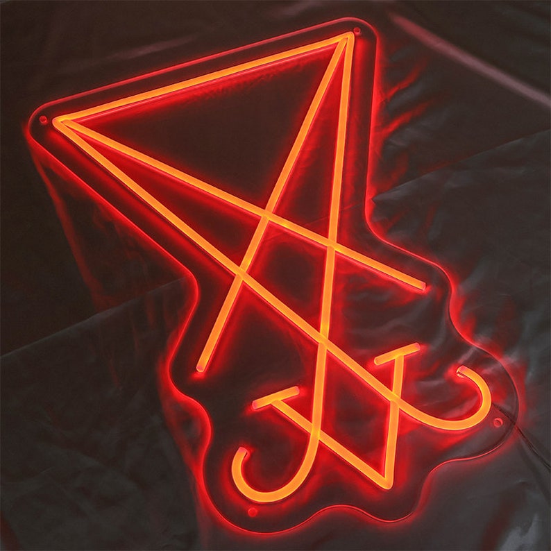 May include: A red neon sign in the shape of a pentagram with a circle in the centre. The sign is lit up and glowing.