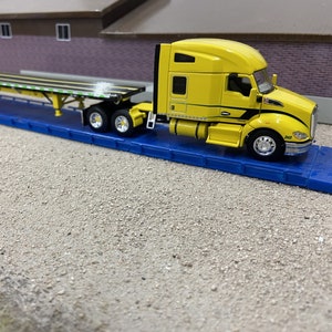 DCP 601690 – “All Year Long” Kenworth T680 with 76" Midroof Sleeper & Wilson Flatbed Trailer (1/64 Scale)