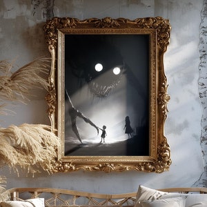 May include: A framed art print with a gold ornate frame. The artwork depicts a dark, surreal scene with a shadowy figure, two glowing eyes, and two small figures. The print hangs above a wicker sofa with pillows.