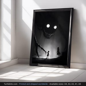 May include: Black and white framed art print depicting a nightmarish scene. A large, shadowy creature with glowing eyes looms over two small figures. The print is displayed against a white wall and floor, creating a stark contrast.