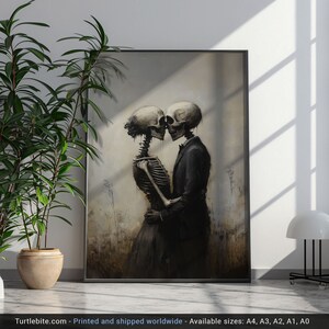 May include: A framed wall art print featuring a dark, painterly illustration of two skeletons embracing in a field. One skeleton wears a dark suit, while the other wears a dark dress. The text at the bottom reads: Turtlebite.com - Printed and shipped worldwide - Available sizes: A4, A3, A2, A1, A0.