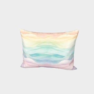 May include: A rectangular cushion with a pastel rainbow design. The cushion has a soft, watercolour-like effect with shades of pink, yellow, blue, and green.