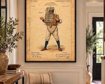 May include: A framed vintage patent print titled J. E. Bennett Base Ball Catcher dated March 23, 1904. The illustration shows a baseball player wearing a large, box-like wire cage mask and chest protector, with technical labels and handwritten notes.