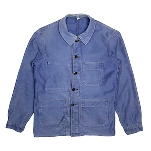May include: A blue work jacket with a collared neckline and four front pockets. The jacket has a button-up closure with black buttons and long sleeves. The fabric appears to be a durable cotton or similar material.
