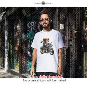 May include: White t-shirt with a graphic of a teddy bear wearing sunglasses and a bandana, riding a motorcycle.
