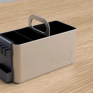 May include: A silver metal organiser with a black interior and a handle. The organiser has three compartments and a small side pocket. The organiser has an infinity symbol on the front.