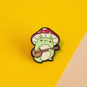 Folk Music Frog Enamel Pin - Quirky Amphibian Musician Accessory for Strumming Along