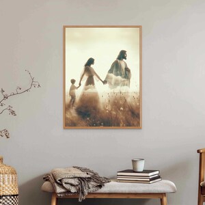 May include: Framed art print depicting a serene scene of three figures walking through a field. The figures are holding hands, with a soft, ethereal glow surrounding them. The artwork is in a wooden frame.
