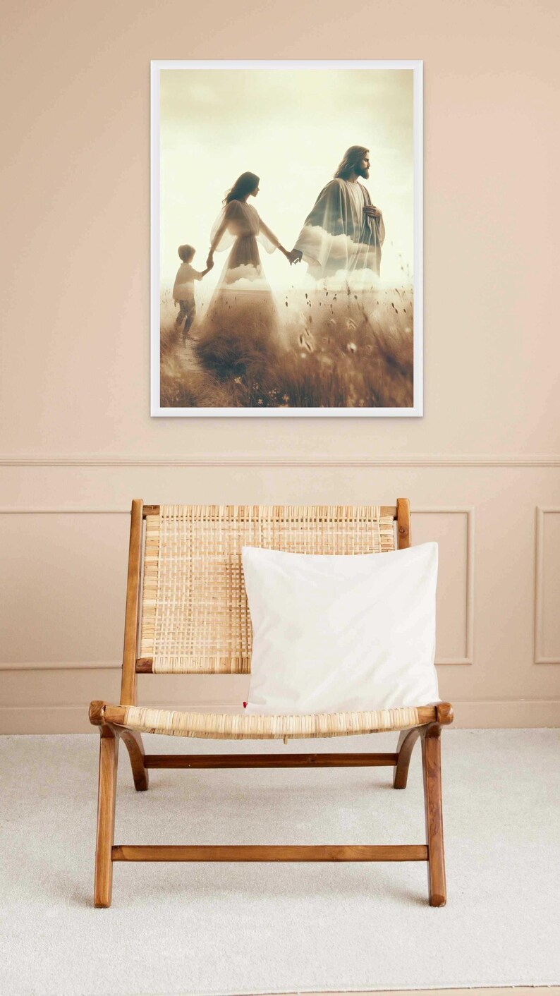 May include: A framed print depicts a family walking through a field, with a man and woman holding hands and a child following. The image has a soft, ethereal quality, with a sepia-toned color palette. A wooden chair with a woven seat and a white pillow is in the foreground.