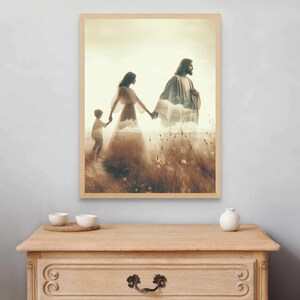 May include: A framed print depicts a serene scene of a family walking through a field. The artwork features a layered effect, with a figure in flowing robes and a child holding hands. The color palette is warm, with earthy tones and a soft, ethereal quality.
