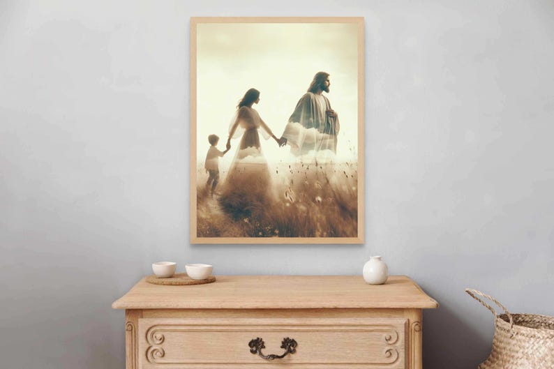 May include: A framed print depicts a serene scene of a family walking through a field. The artwork features a layered effect, with a figure in flowing robes and a child holding hands. The color palette is warm, with earthy tones and a soft, ethereal quality.