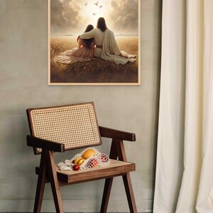 May include: A framed print depicts two figures embracing in a field, bathed in sunlight, with birds in the sky. A wooden chair with a woven seat holds a net bag of fruit. A white curtain hangs on the right.