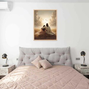 May include: A framed print depicting two figures seated together, bathed in warm sunlight. The artwork features soft colors and a serene landscape, evoking a sense of peace and comfort. The print is displayed above a bed with a tufted headboard.