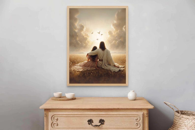May include: A framed print depicts two figures seated in a field, bathed in sunlight. One figure has an arm around the other. Birds fly in the sky above. The artwork is in a wooden frame.