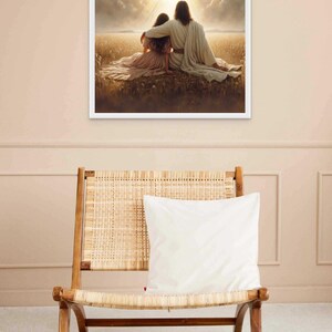 May include: A framed print depicts two figures seated in a field, bathed in sunlight. One figure has an arm around the other. Birds fly in the sky above. The print is displayed above a wooden chair with a woven seat and a white pillow.
