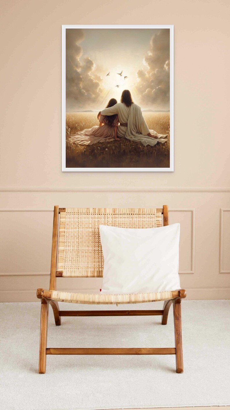 May include: A framed print depicts two figures seated in a field, bathed in sunlight. One figure has an arm around the other. Birds fly in the sky above. The print is displayed above a wooden chair with a woven seat and a white pillow.