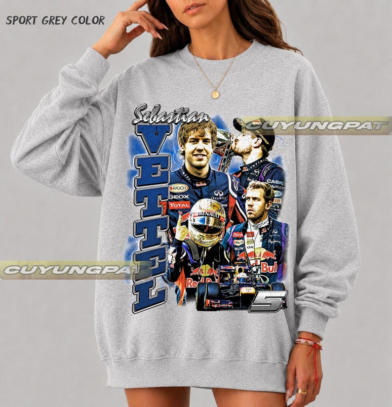 May include: A sport grey crewneck sweatshirt featuring a graphic print of Formula One driver Sebastian Vettel. The design includes multiple images of the driver in racing gear, a race car, the name Vettel in large blue letters, and the number 5.
