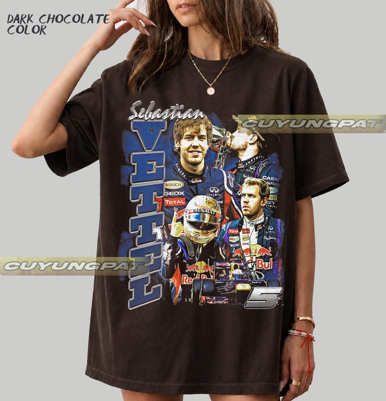 May include: A dark chocolate colored t-shirt featuring a graphic print of Formula One driver Sebastian Vettel. The design includes multiple images of the driver, the text "Sebastian VETTEL", and the number "5" in a bold, blue-toned collage style.