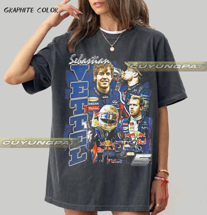 May include: A graphite-colored short-sleeve t-shirt featuring a graphic print of Formula 1 driver Sebastian Vettel. The design includes multiple images of the driver, a racing helmet, a race car, the text Sebastian Vettel, and the number 5.