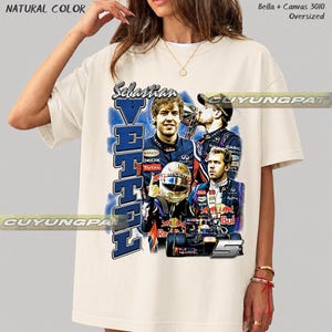 May include: A natural-colored oversized t-shirt featuring a graphic print of Formula 1 driver Sebastian Vettel. The design includes multiple images of the driver, a racing helmet, a race car, and the text Sebastian Vettel in blue and white.