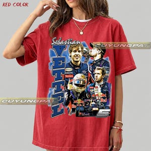 May include: A red short-sleeved t-shirt featuring a graphic print of Formula 1 driver Sebastian Vettel. The design includes multiple images of the driver, a racing helmet, a race car, the text Sebastian Vettel, and the number 5 in a blue background.
