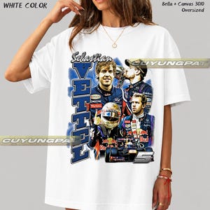 May include: A white oversized t-shirt featuring a graphic print of Formula 1 driver Sebastian Vettel. The design includes multiple images of the driver, a racing helmet, a race car, the text Sebastian Vettel, and the number 5. Text reads Bella + Canvas 3010.
