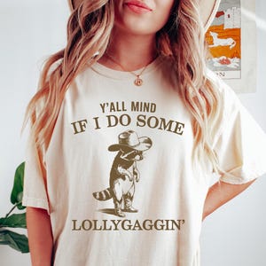 Funny Lollygaggin&#39; Meme Shirt, Y&#39;all Mind If I Do Some Lollygaggin&#39;, Cowboy Raccoon Tshirt, Retro Vintage Graphic Colors, Humorous Gift Tee