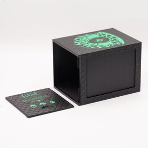 May include: Black box with a green dragon design on the top and a matching lid. The lid has the text "RISE of the DRAGONLORDS" and a skull and green accents. The box is open, revealing the interior.