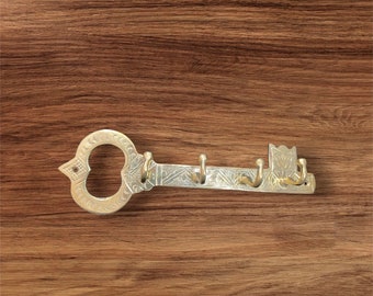 Brass key-shaped hook for hanging keys, towels and coats. Can be placed in the bathroom and kitchen