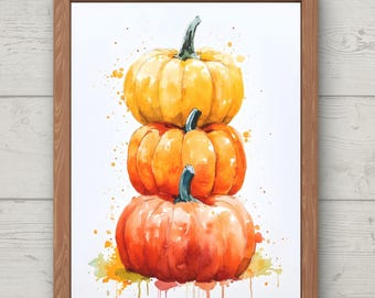 May include: Watercolor painting of three stacked pumpkins in shades of orange and yellow, with green stems. The artwork is framed in a wooden frame and features the text "digital download" and "AntiqueSkylineArt".