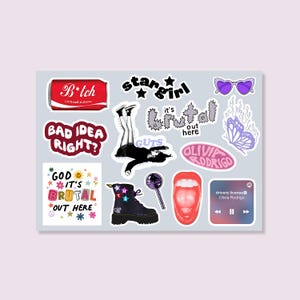 May include: A sheet of stickers with various designs and text. Designs include a red soda can with "B*tch" text, a black boot with star accents, and a purple heart-shaped sunglasses. Other text includes "stargirl" and "drivers license".