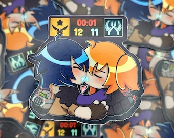 May include: A sticker featuring two cartoon characters kissing, with blue and orange hair. The sticker has a black background with other stickers visible. The characters are embracing, with a heart symbol between them. The sticker has a game-like interface.