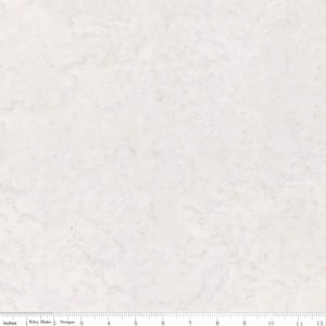 May include: Off-white fabric with a subtle, marbled pattern. The fabric has a soft, textured appearance, with light and dark areas creating a visual depth. A ruler is at the bottom, showing inches.