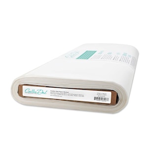 May include: A roll of white fusible web paper backed interfacing. The label reads "Callie Del Interfacing" and "Fusible Web Paper Backed". The roll measures 17in x 35YD.
