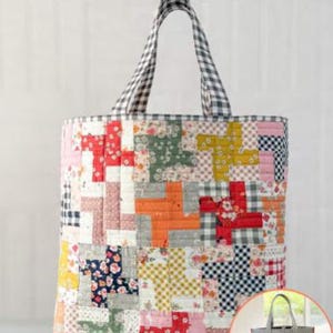 May include: A large, quilted tote bag with a patchwork design in various colors, including red, pink, orange, and green. The handles are black and white checkered. The text "Quilter's Big Tote" is at the top. A smaller, reversible bag is shown in a circle.