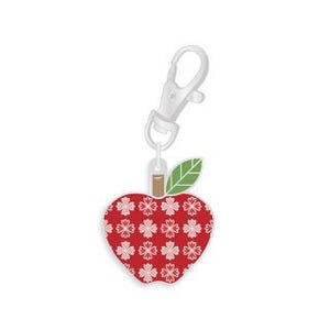May include: A red apple-shaped charm with a white floral pattern and a green leaf. The charm is attached to a silver-coloured lobster clasp. The apple charm is approximately 3.8 cm wide.