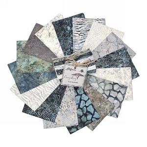 May include: A pack of 12 fat quarter fabric squares in a variety of blue and white patterns. The fabric squares are arranged in a fan shape and feature a label that reads "Hoffman, Congo Bag, 12 Fat Quarters".